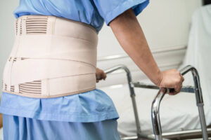 classic asian-lady-patient-wearing-back-pain-support-belt-2023-01-17-05-21-47-utc